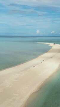 Sandy beach with crystal clear water in the tropics. Timba Timba islet. Tun Sakaran Marine Park. Borneo, Sabah, Malaysia. Vertical video.