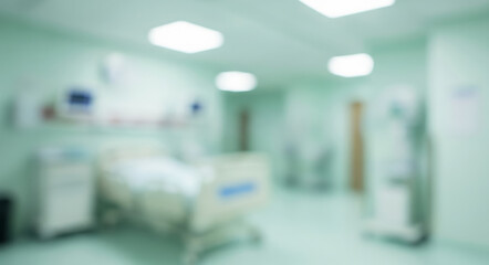 Blurred hospital room interior with bed medical equipment and light green walls.