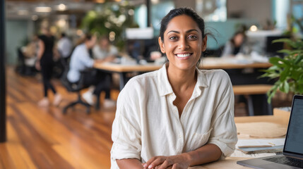 young beautiful woman sitting in the office and smiling