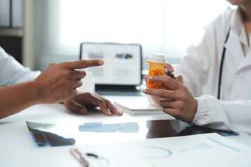 Doctors discussing about patient's medical treatment with pills and x ray