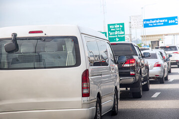 Cars waiting to enter a toll booth during rush hour in Bangkok, Thailand