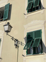 Old street in Italian countryside near sea. Traditional building. Sun day. Entrance, window to house. Background and sky.