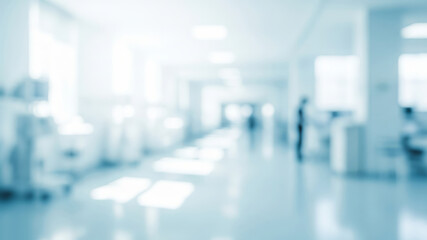 Blurred hospital hallway with beds and medical equipment in a bright setting.