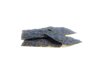 Stacked roasted seaweed snack sheets on a white background, close-up food detail.