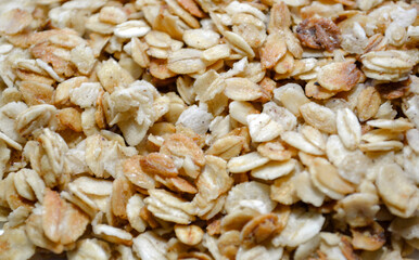 Healthy breakfast granola background. Macro shot of toasted rolled oats and whole grains cereal. 
