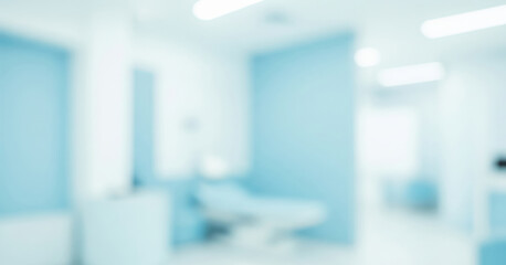 Blurred image of a hospital room interior with medical equipment and light blue tones.