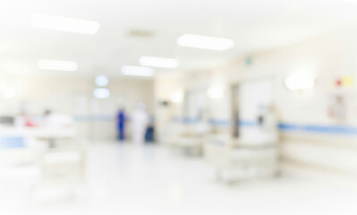 Blurred hospital interior with medical equipment and personnel in the background.