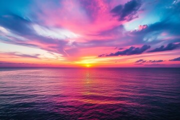 Obraz premium Stunning Vibrant Sunset Over Vast Ocean Panorama with Colorful Sky Reflections on Calm Water