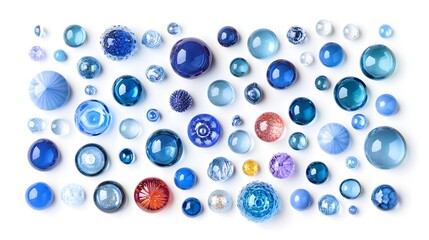 Arrangement of various sized and colored glass beads on a white surface in a studio shot style