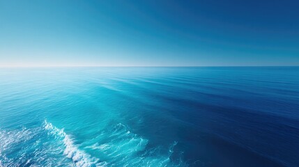 capture drone-shot aerial view of vast ocean expanse where serene water meets horizon offering breathtaking top-down