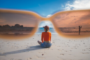 happy woman sit down on the beach at krabi province, Thailand. soft focus
