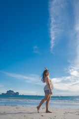 happy woman stand on the beach at krabi province, Thailand. soft focus
