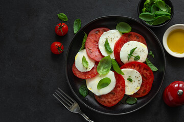 Caprese salad with fresh tomatoes, mozarella cheese, basil and olive oil