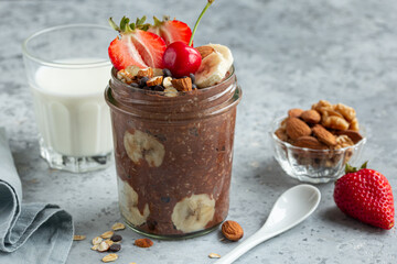 chocolate overnight oats with fresh berries,  banana and  nuts