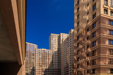 Fototapeta premium City view on a sunny day. Modern houses against the blue sky.