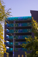 Cityscape on a summer day, modern buildings and houses against the blue sky 