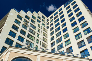 Fototapeta premium City view on a sunny day. Modern houses against the blue sky.