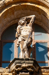 Donostia-San Sebastian, Spain: the statue of San Sebastian pierced by arrows on the facade of the Basilica of Saint Mary of the Chorus, baroque Roman Catholic parish church completed in 1774, one