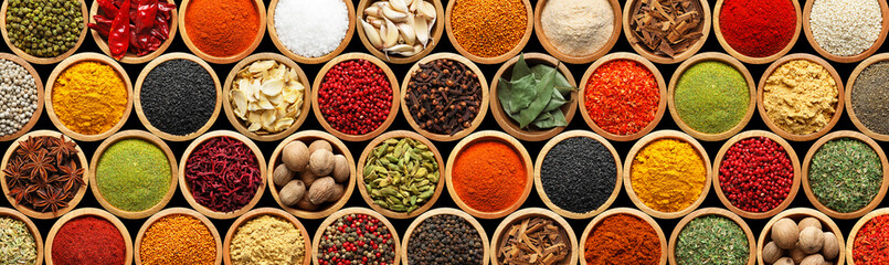 Set of different aromatic spices in bowls on black background, flat lay. Banner design