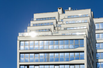 Cityscape on a sunny day. Modern building against the blue sky.
