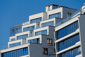 Cityscape on a sunny day. Modern building against the blue sky.