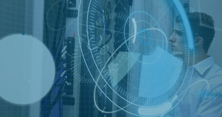 Inspecting technician in dress shirt reaching toward network switches in server room, copy space