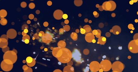 Displaying overlapping orange-yellow bokeh circles over navy backdrop, with white spark highlights