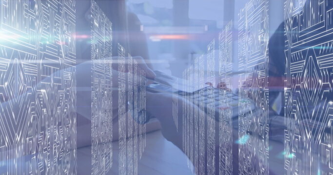 Typing IT professional blending laptop hardware with data overlays in server room, circuit board - Powered by Adobe