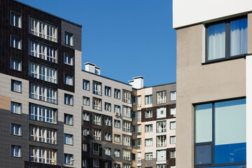 Obraz premium City view on a sunny day. Modern houses against the blue sky.