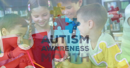 Collaborating classmates painting on paper at library table, with brush and autism awareness banner