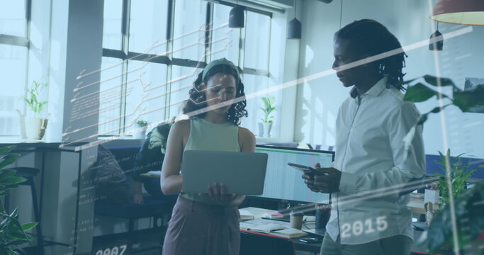 Collaborating developers reviewing code on laptop and tablet in open-plan office, with code overlay