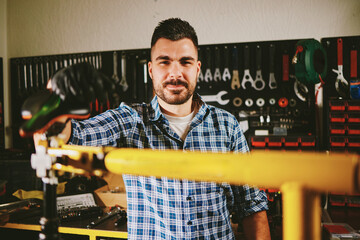 Bicycle mechanic repairing bike in workshop