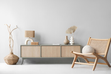 View of modern scandinavian style interior with chair, commode and trendy lamp. Elegant living room...