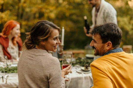 Couple enjoying conversation at outdoor autumnal dinner party