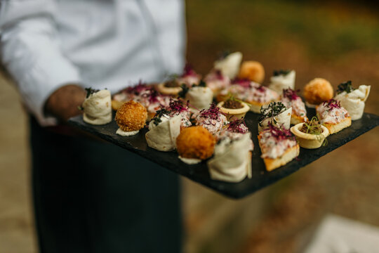 Waiter carrying tray of gourmet appetizers at a celebration event