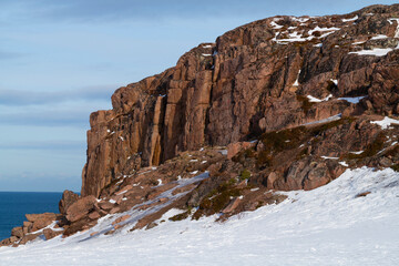 Red rocks on a sunny March day. Teriberka Nature Park. Murmansk Region, Russia