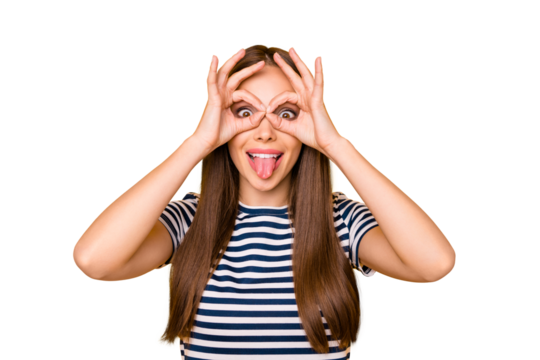 Portrait of cute teenager making spectacles with her fingers wearing striped t-shirt isolated over yellow background