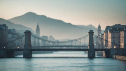 Obraz premium Blurred old fashion city background in the morning pale light with bridge and water in front and mountain in back, with empty copy space for text