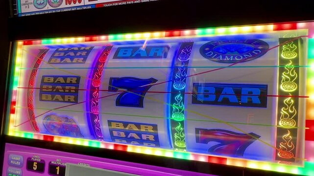 Colorful flashing lights on slot machine 777 jackpot, casino gambling