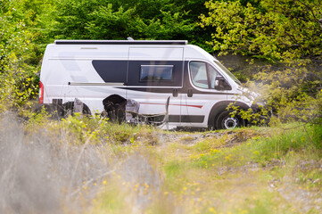 Camper van or motorhome is free camping on the side of the road on Buško lake, Bosnia and Herzegovina. Wild camping in Bosnia, Greece or Croatia in nature next to the lake.