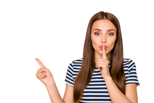 Photo of funny lady indicating finger empty space asking keep news in secret wear striped t-shirt isolated yellow background