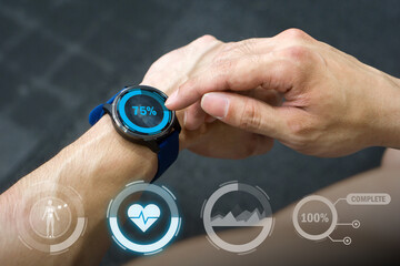 Fototapeta premium In a gym setting, an individual review health statistic on a smartwatch while exercising. The device display various metric like heart rate and activity completion.