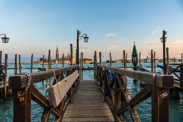 Wooden pier leading to san giorgio maggiore in venice at sunset