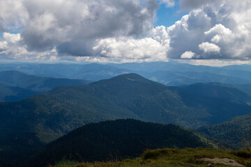 Naklejka premium Fantastic scene of green meadows and forested mountain ranges in sunny weather. Location place Carpathians, Ukraine, Europe. Ecologically clean area. Photo wallpapers. Discovery the beauty of earth.
