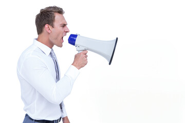 Fototapeta premium Twentysomething man wearing suit raising white and blue megaphone to mouth in studio, copy space