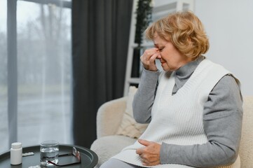 Senior woman suffering from a headache