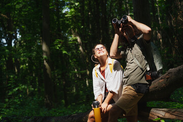 Beautiful young couple relaxing after hiking and taking a break