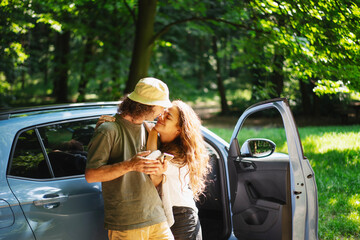 Happy young couple in love travelling by car to the countryside..Summer vacation and travel concept
