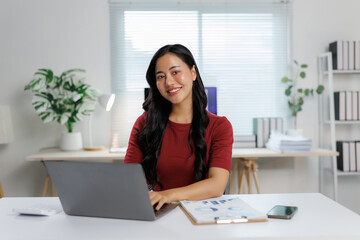 Asian businesswoman working with laptop in modern office