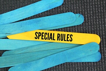 Colored wooden sticks with the text special rules. specific rule that only applies to a particular situation or circumstance.